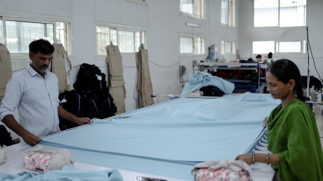 Fabric being spread and laid on the cutting table