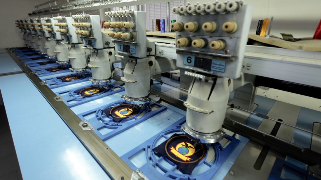 A crest being embroidered directly onto a garment