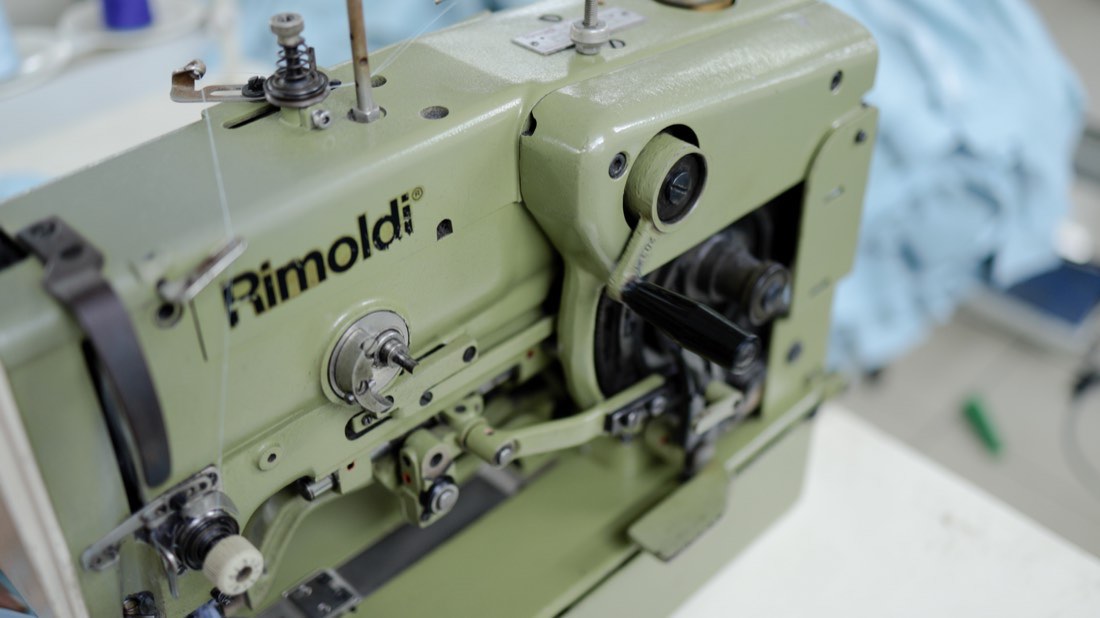 Close view of an industrial overlock machine head